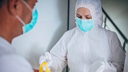 Health workers wearing full protective gown and mask