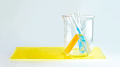 Beaker containing vials of colorful liquids