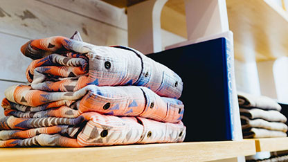 Stack of folded shirts on shelf