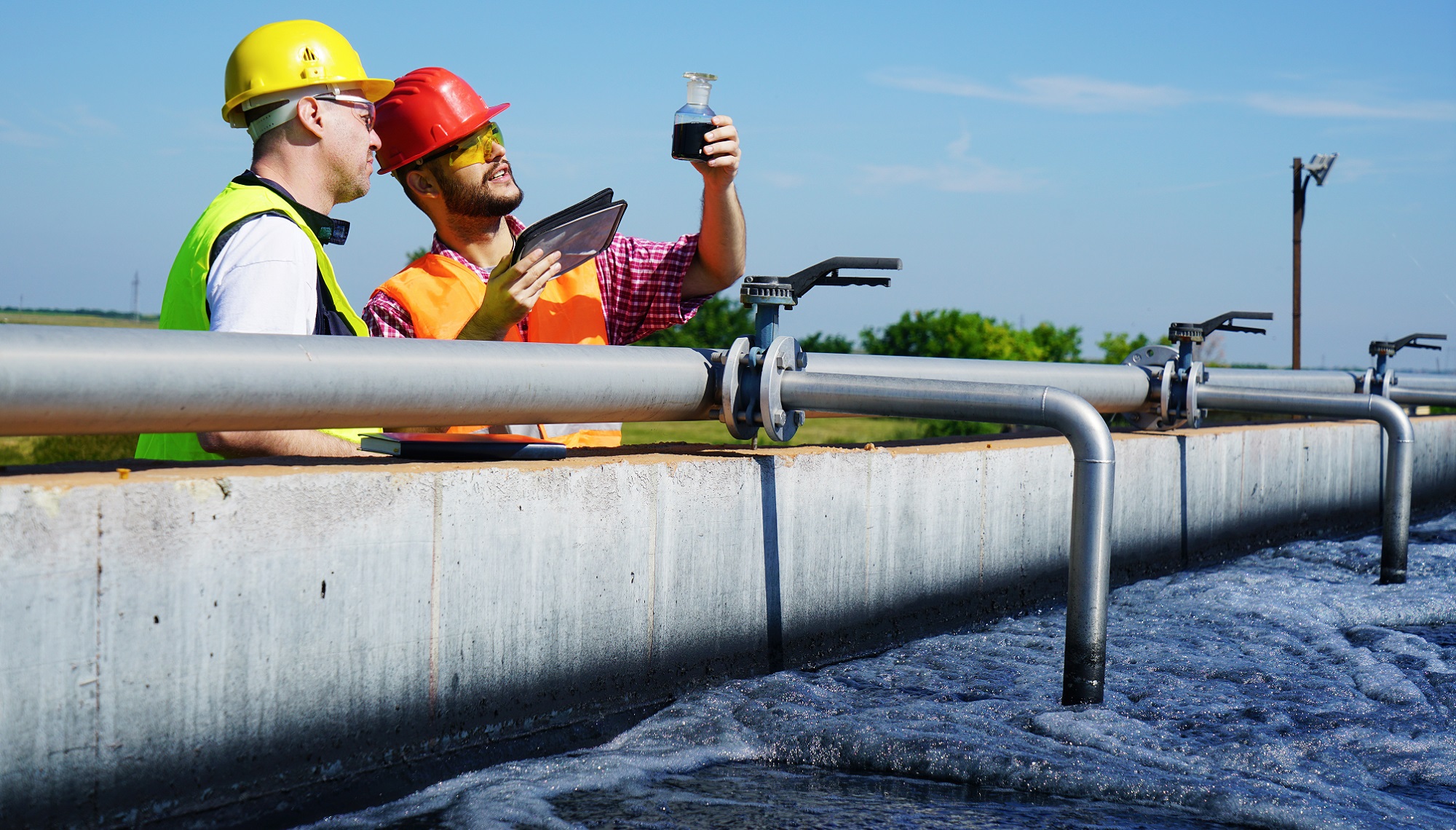 Two specialists investigating the wastewater in the factory.