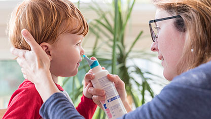 Child receiving inhaler medication