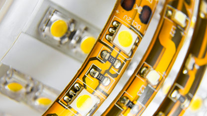 Close-up of LED strip lights showing individual LED chips and circuitry on a flexible circuit board.