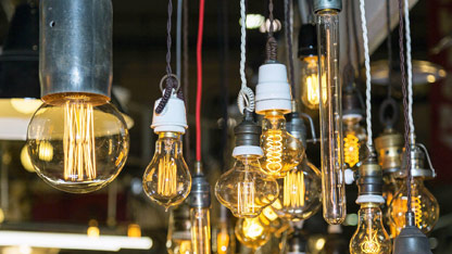 Group of different kinds of Vintage Light Bulbs with Incandescent Filament hanging from a ceiling