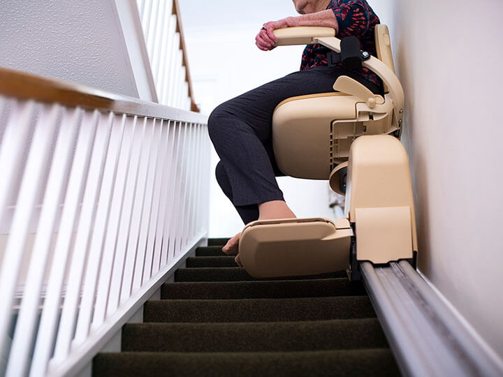 Elderly person riding stairlift