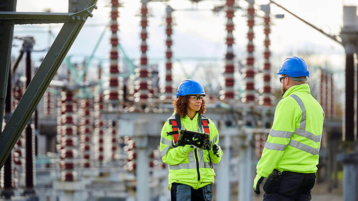 Two workers talking in an energy plant