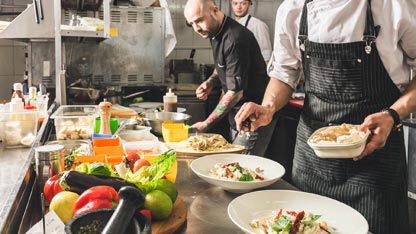 Restaurant workers preparing dishes